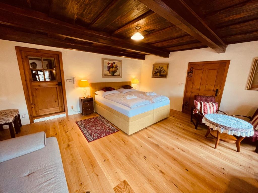a bedroom with a bed and a table and chairs at Penzion Kapr in Český Krumlov