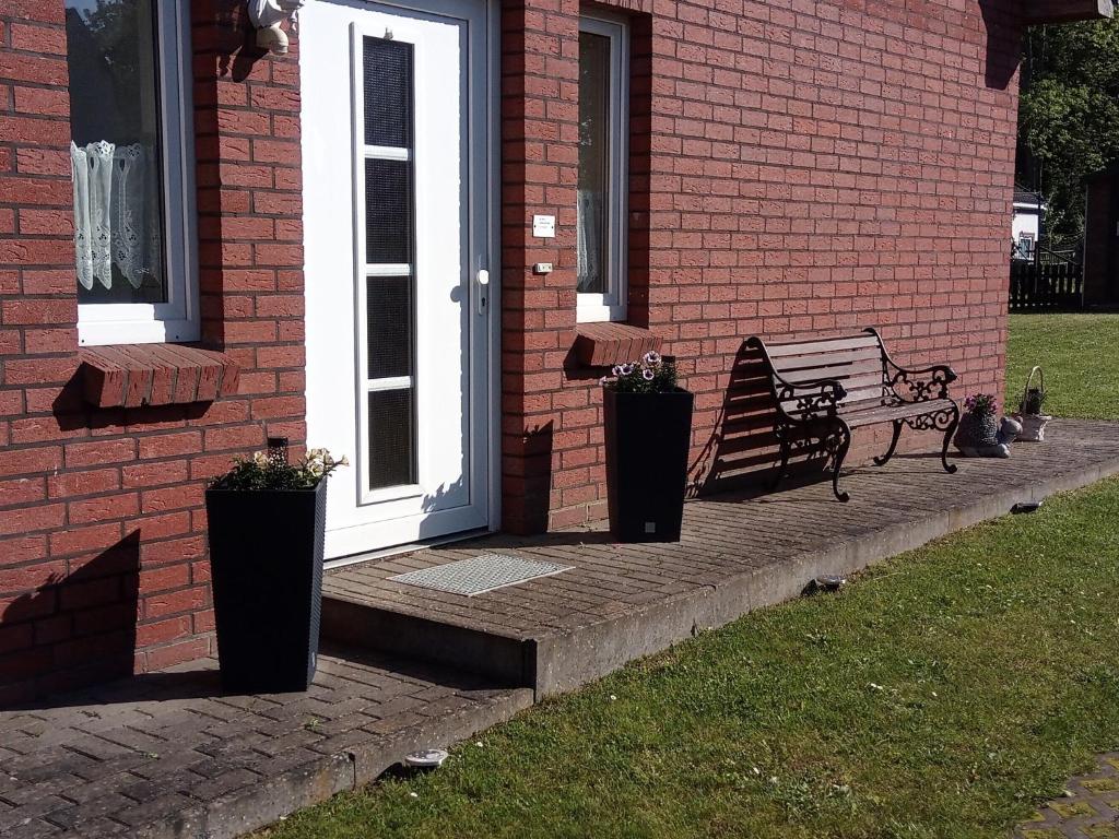 a bench sitting on a porch next to a door at Ferienwohnung "Dorfidyll" in Kneese Dorf