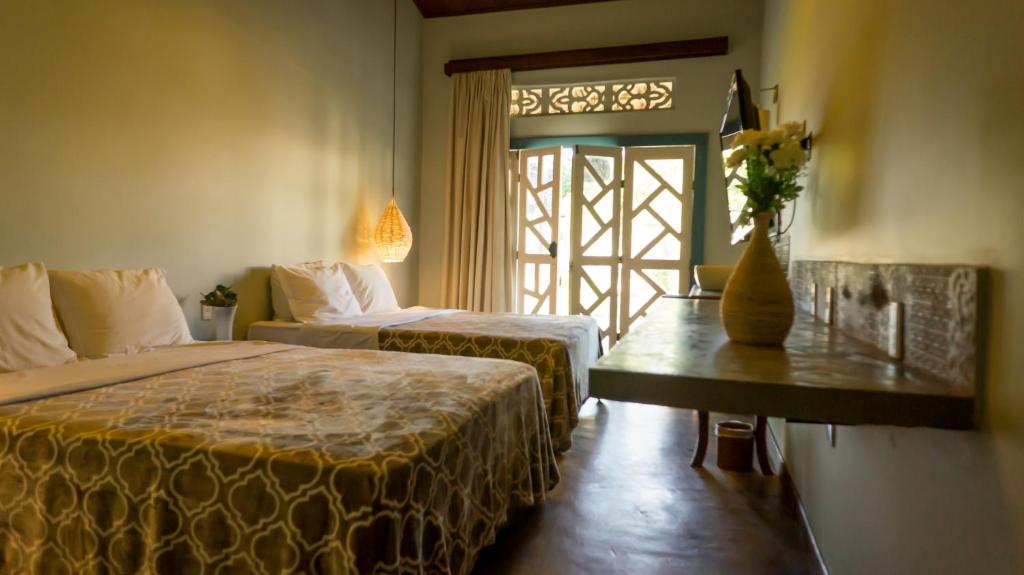 Ένα ή περισσότερα κρεβάτια σε δωμάτιο στο POUSADA LA BELLE D'JOUR - PIPA/RN