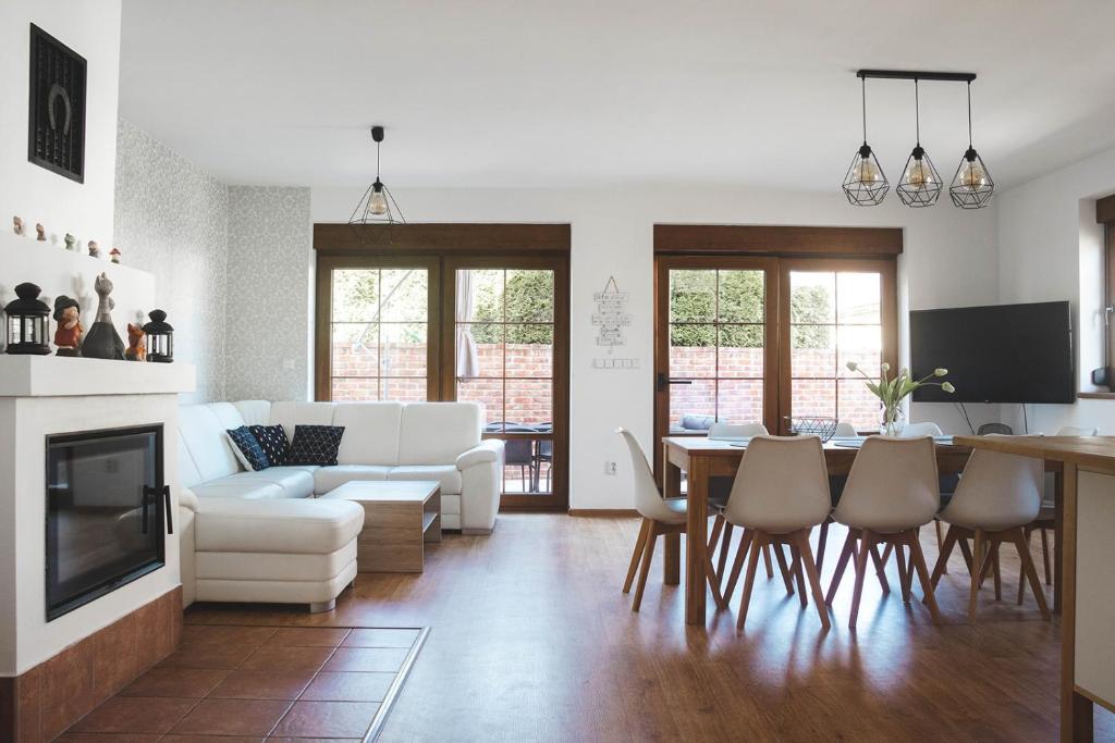 a living room with a white couch and a table at Rekreační dům U Skřítků in Mladé Buky