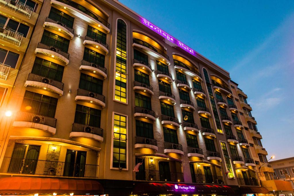 a large building with a lit up sign on it at Heritage Hotel in Tawau