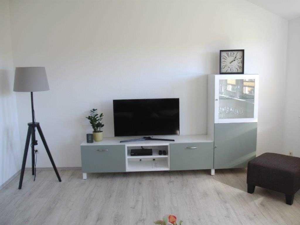 a living room with a flat screen tv on a entertainment center at Ferienwohnung Hinz in Neu Lüdershagen
