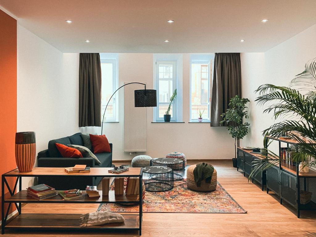 a living room with a couch and a table at Brunnen Apartments in Nuremberg