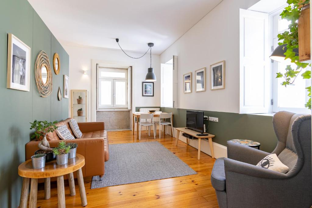 a living room with a couch and a table at Cozy Studio Apartment in Porto
