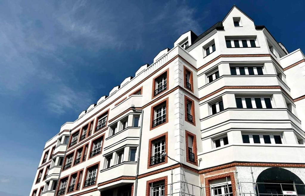 a tall white building with a sky in the background at Neoresid Paris-Gagny in Gagny