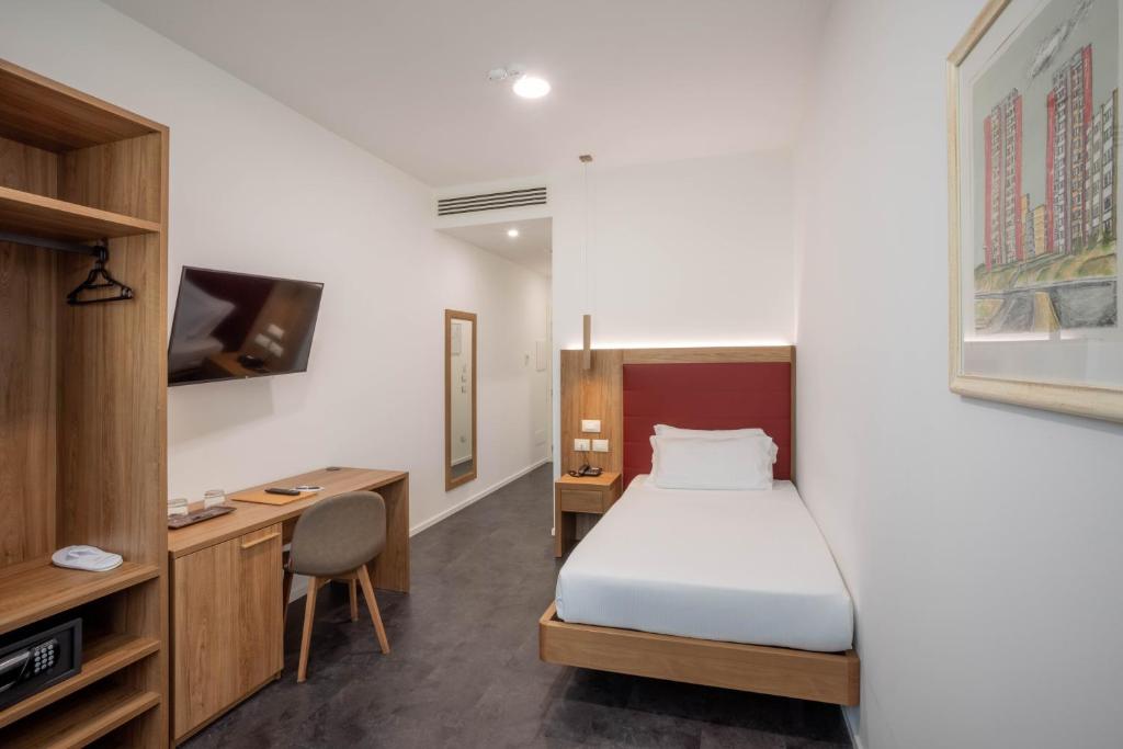 Postel nebo postele na pokoji v ubytování V Hotel