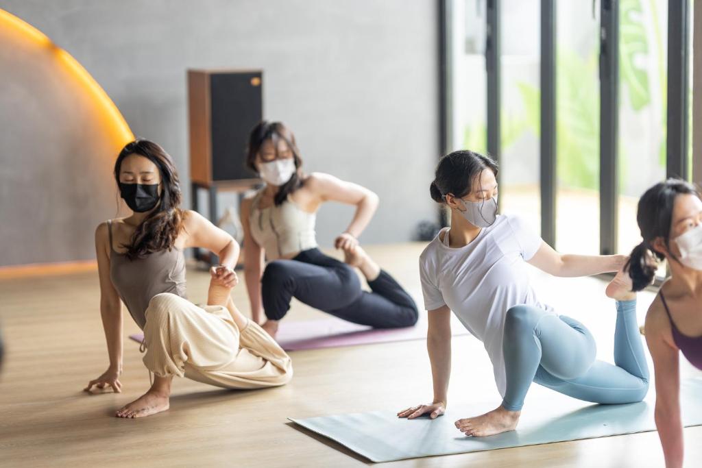 un groupe de femmes assises dans un cours de yoga dans l'établissement Bedradio Dodubong, à Jeju