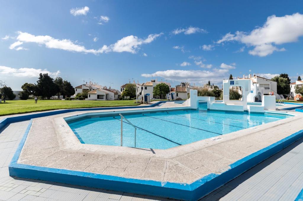 a swimming pool in the middle of a house at Akisol Santa Luzia Teltale in Santa Luzia