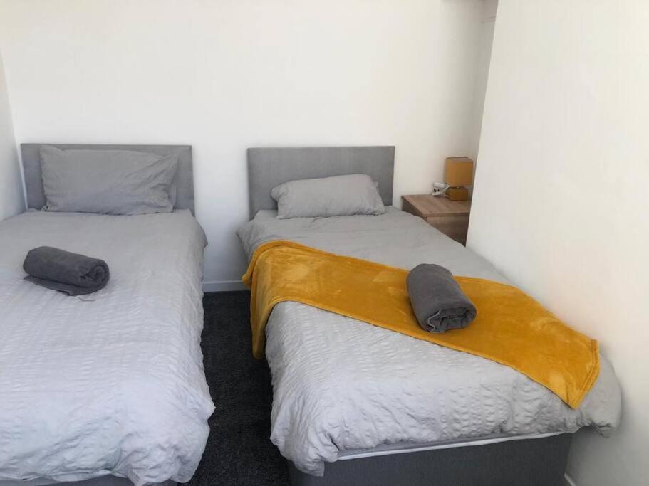 two twin beds in a room with two pillows at Modern 2 bed sleep 5 close to Anfield Stadium in Liverpool