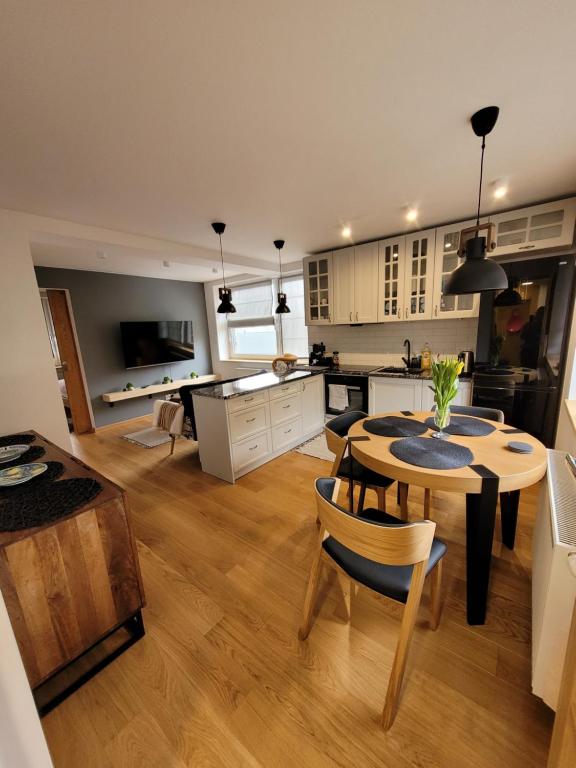 a kitchen and living room with a table and chairs at Na Bogówce in Zakopane