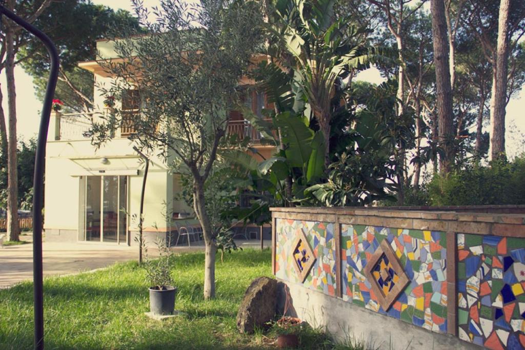 a fence with a colorful mosaic wall in front of a house at Al Corbezzolo in Torre del Greco