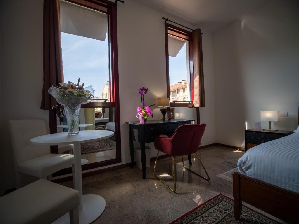 A bed or beds in a room at Ego' Residence Ferrara