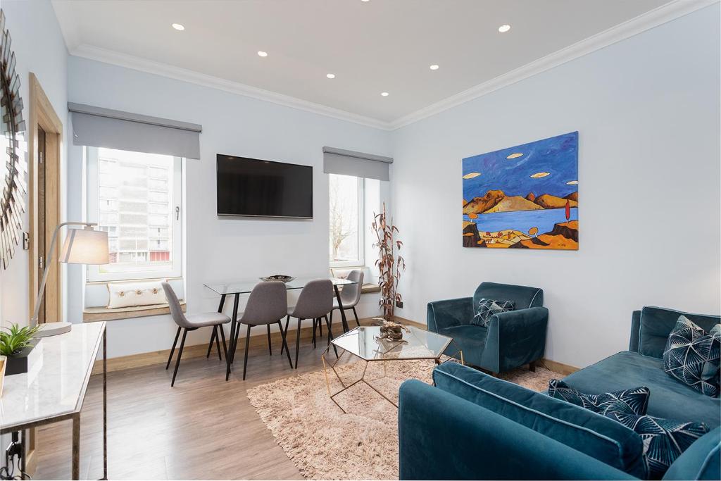 a living room with a couch and a table at The Barclay Apartment in Perth