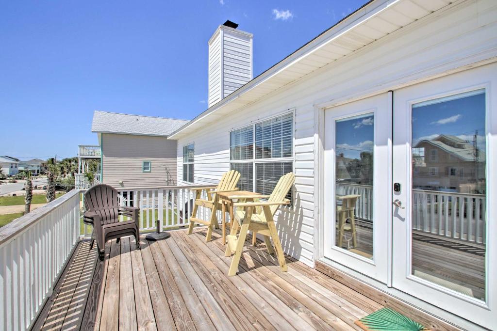 a wooden deck with chairs and a table on it at Pensacola Beach Home 1 Block to Beach Access in Pensacola Beach