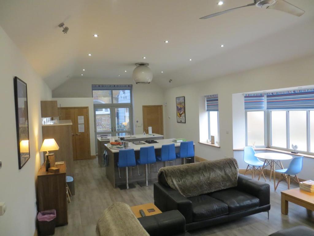 a living room with a couch and a kitchen at Lynnfield Hall in Hunstanton