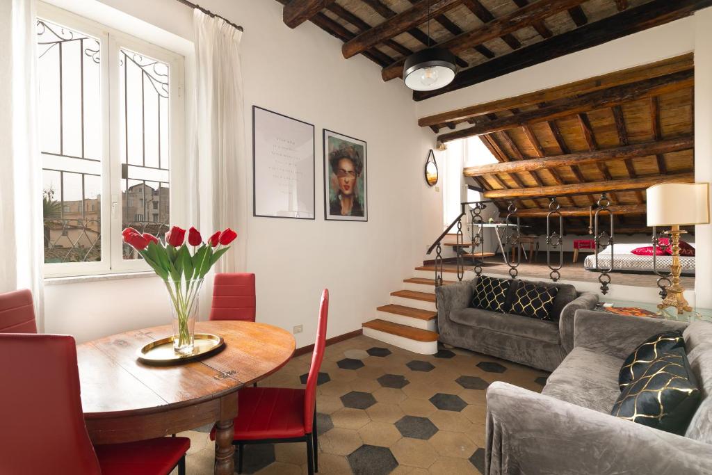 a living room with a table and a couch at Rooftop Campo dei Fiori in Rome