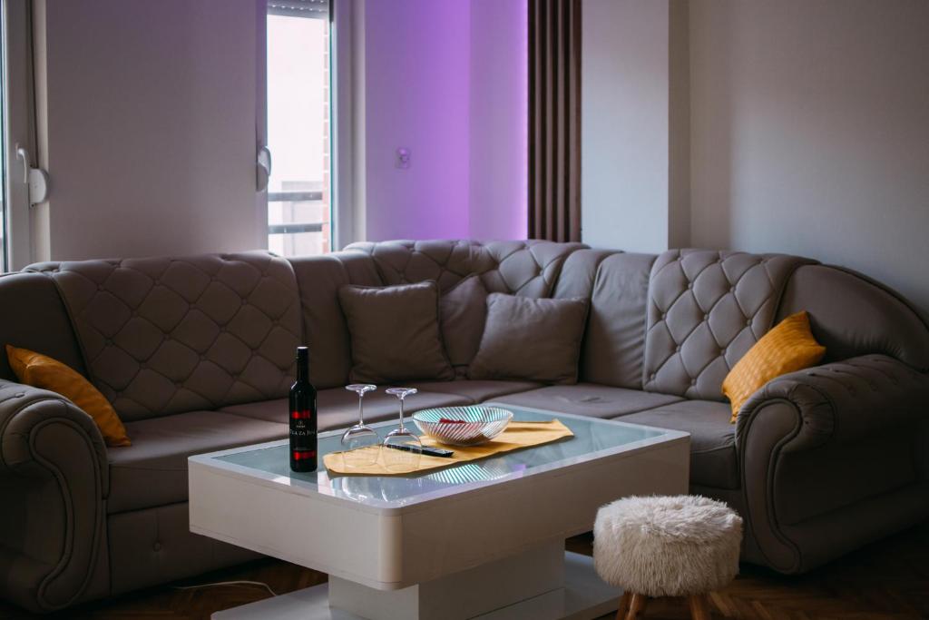 a living room with a couch and a table at Wel Apartment in Gevgelija