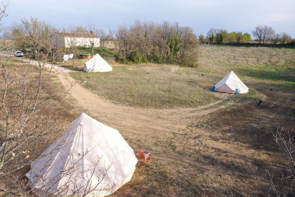 two tents in the middle of a field at Camping Arbre de Vie in Montagnac