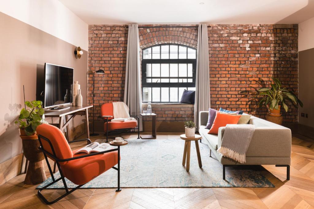 a living room with a brick wall at Native Manchester in Manchester