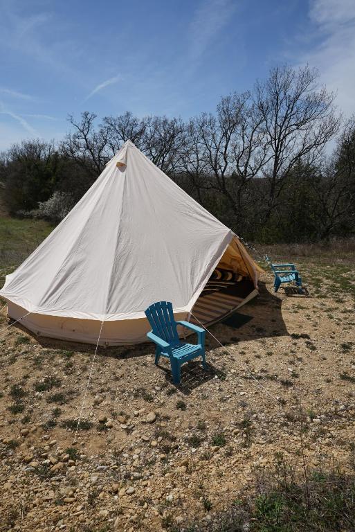 a large tent with two chairs and two chairs at Camping Arbre de Vie in Montagnac