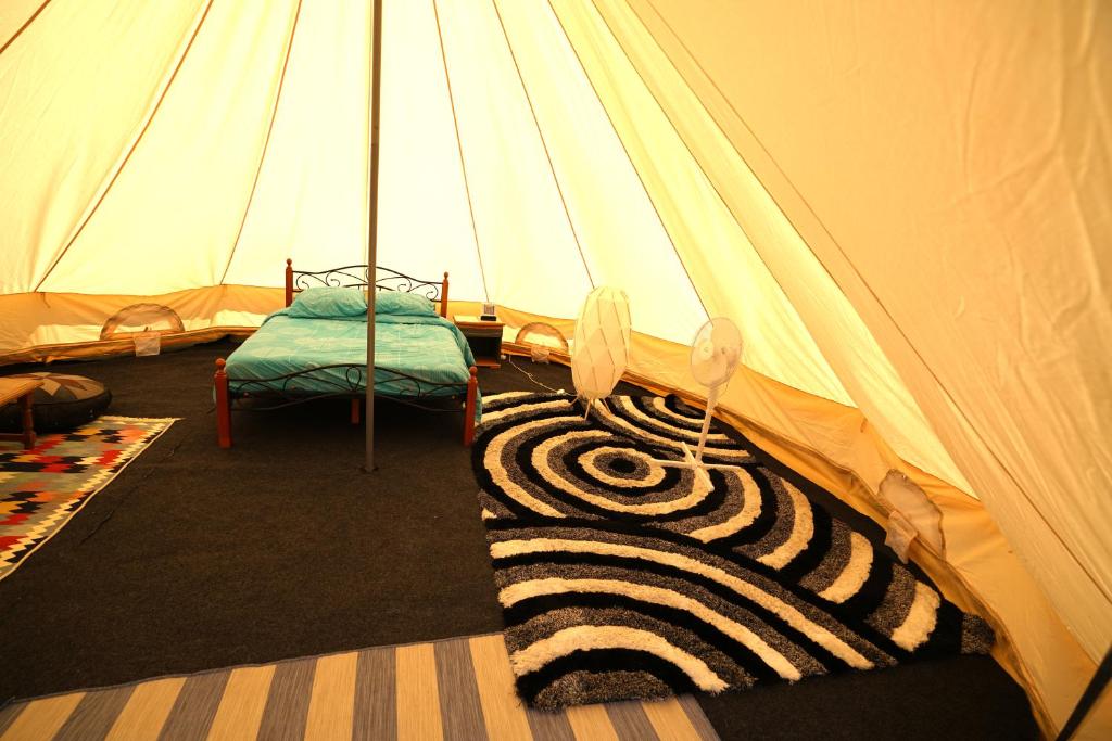 a tent with a zebra rug in a room at Camping Arbre de Vie in Montagnac