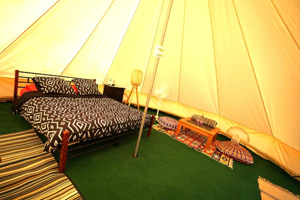 a bedroom with a bed in a tent at Camping Arbre de Vie in Montagnac
