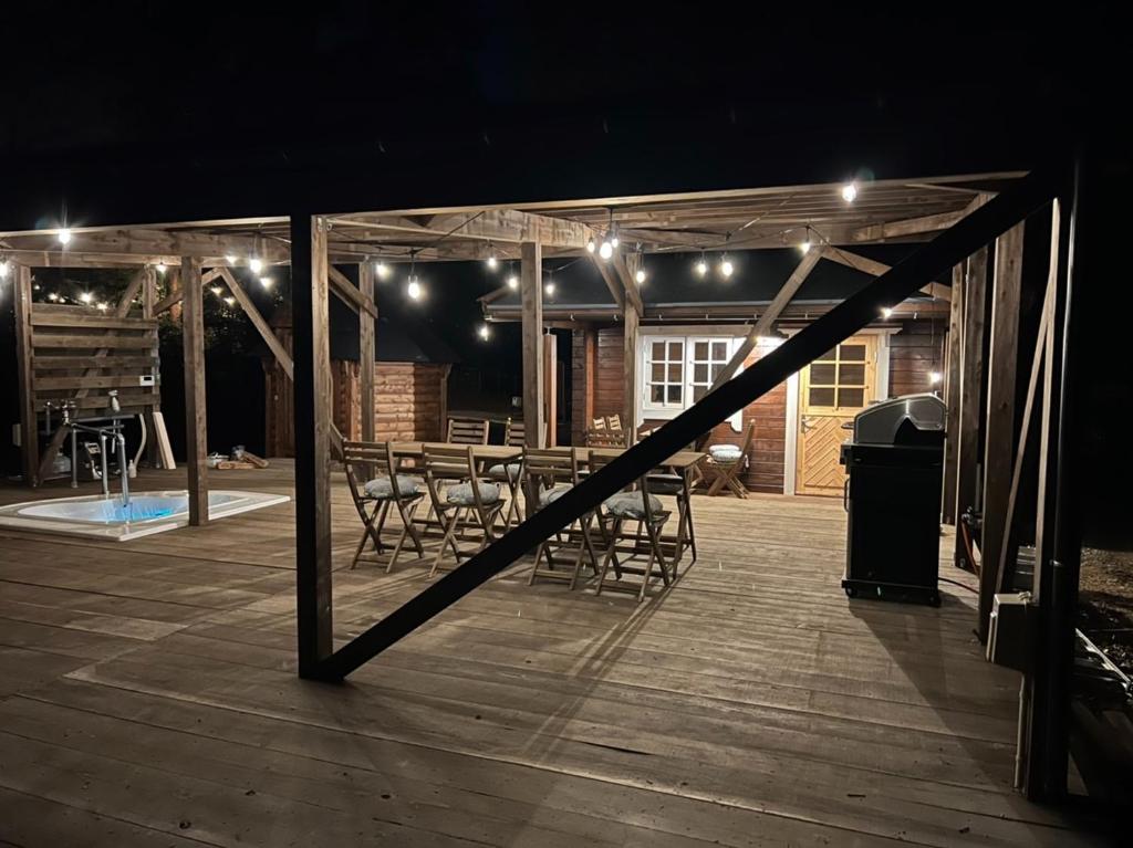 a wooden deck with a table and chairs at night at Jyuuraku no mori - Vacation STAY 50432v in Awara