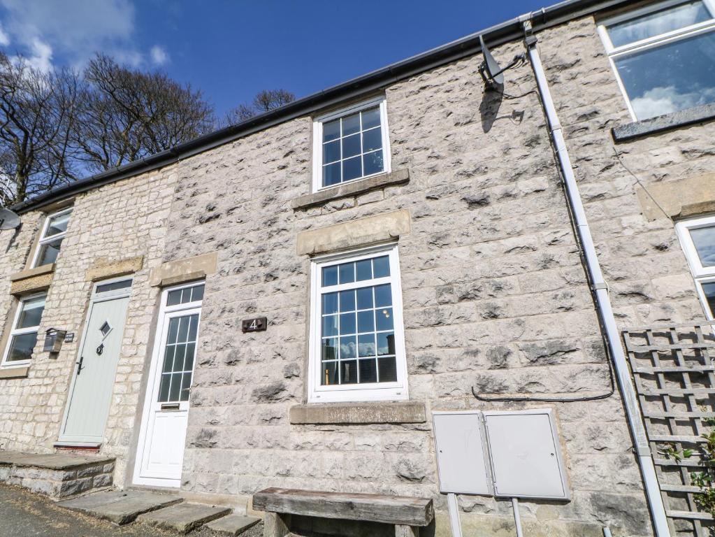 a stone building with white doors and windows at 4 Alma Road in Buxton
