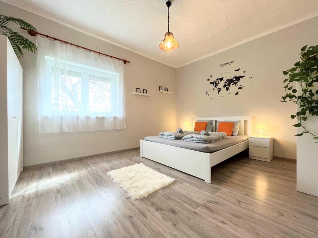 a bedroom with a bed and a large window at Holiday Home Szulok in Szulok