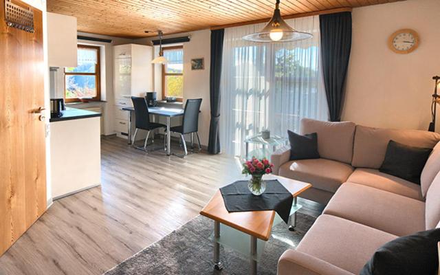 a living room with a couch and a table at Haus Ulrike-Maria in Badenweiler