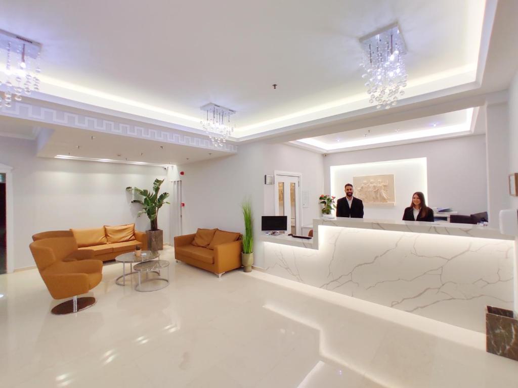 a lobby with two people in a waiting room at Hotel Parthenon Rodos city in Rhodes Town