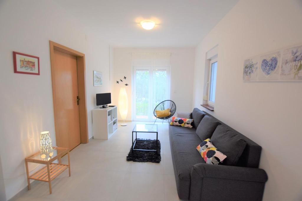 salon z kanapą i stołem w obiekcie Holiday Home Movica w mieście Mandre