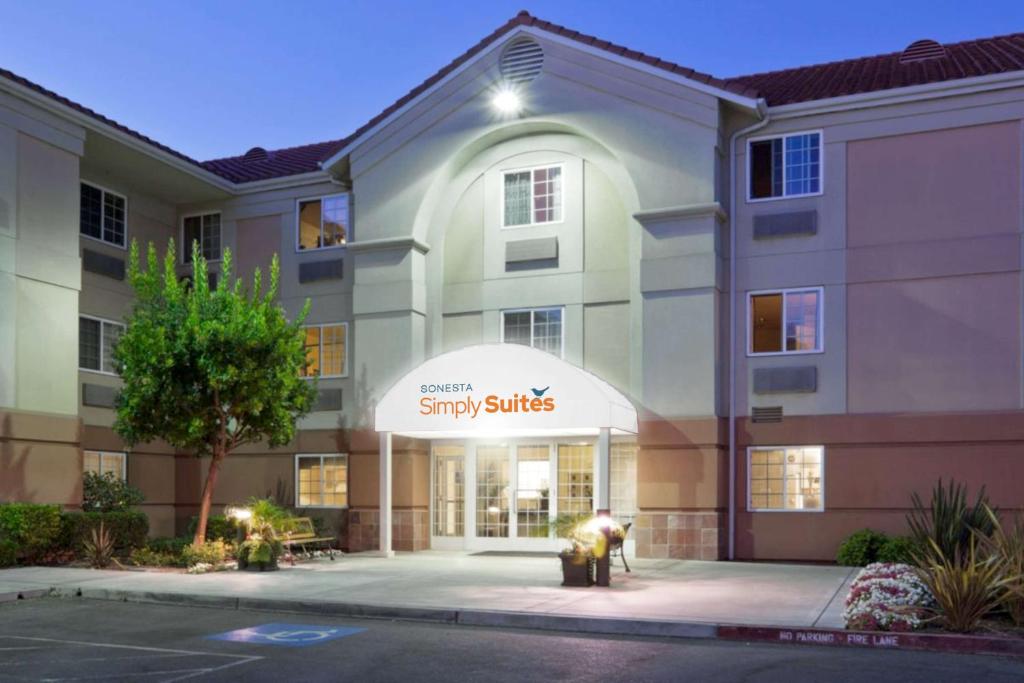 a building with a sny sticks sign on it at Sonesta Simply Suites Silicon Valley Santa Clara in Santa Clara