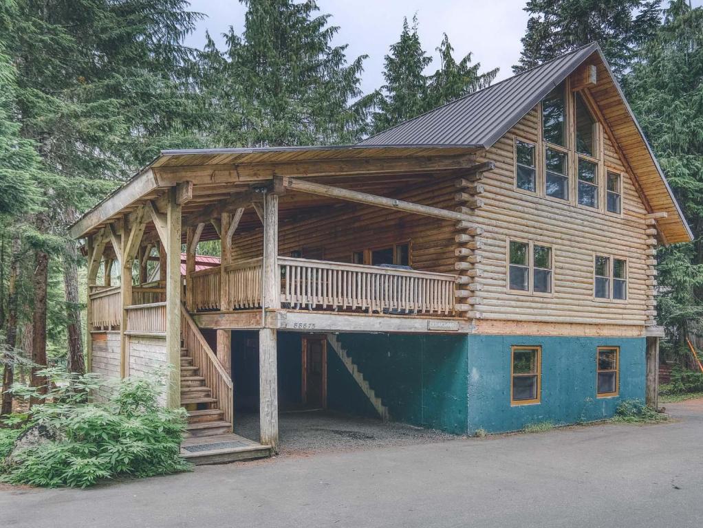 een blokhut met een terras en een veranda bij Cedarwood Lodge in Government Camp