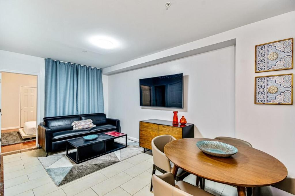 a living room with a table and a couch at Bee Home in the City in Philadelphia