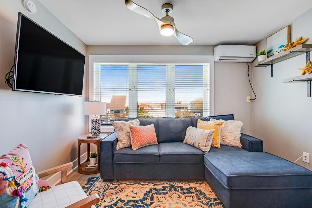 a living room with a couch and a flat screen tv at Boho Bayshore 42 in Ocean City