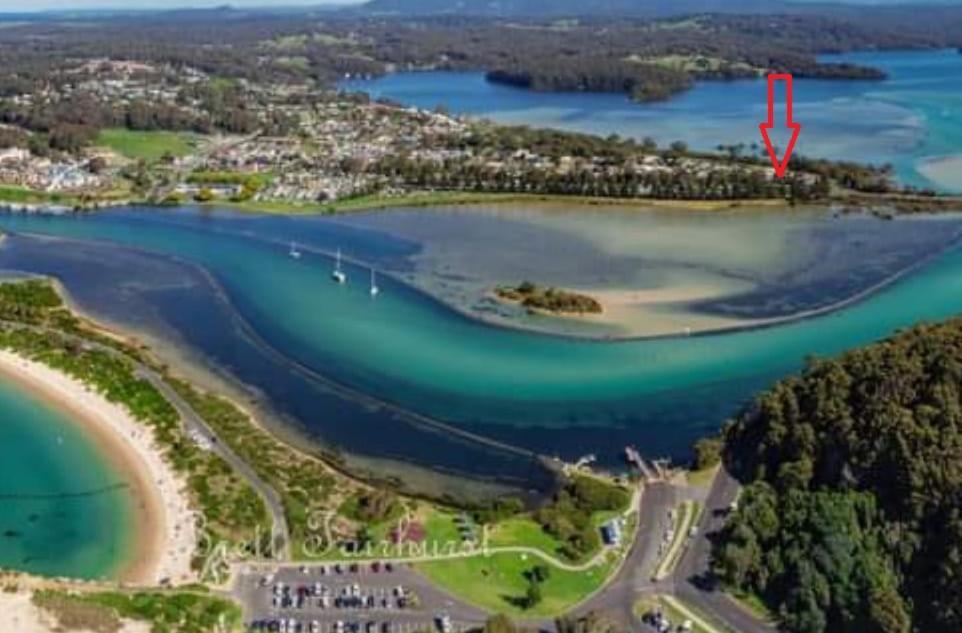 an aerial view of a beach with a red arrow pointing into it at The Boathouse a 3 Bedroom Holiday Home in Narooma