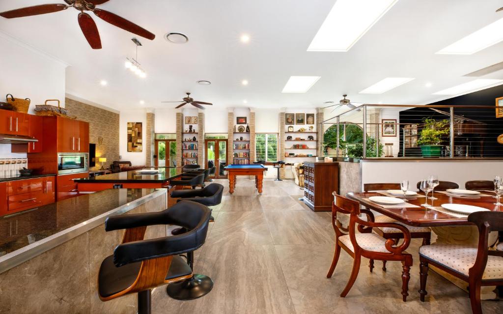 een keuken en eetkamer met een tafel en stoelen bij Luxury Penthouse 5 BDR 3 Bath Twin Rain Showers 365 sq mtrs in Port Douglas