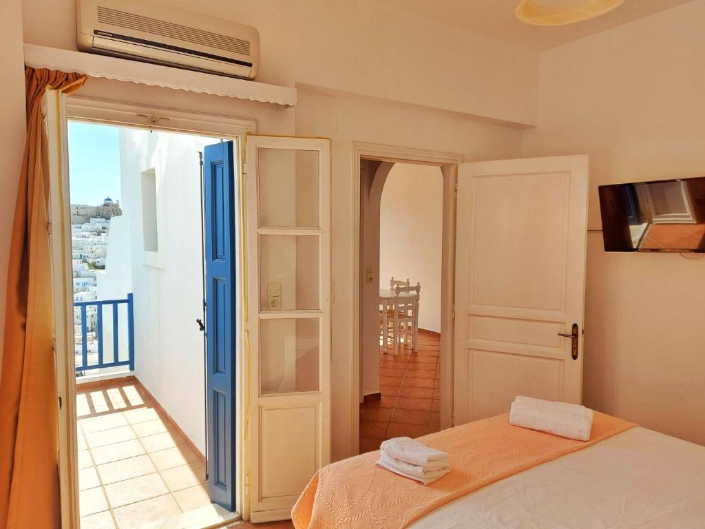 a bedroom with a bed and a balcony at Castelli Studios in Astypalaia Town