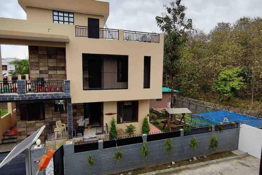 a house with a swimming pool in front of it at Nature Villa in Haldwāni