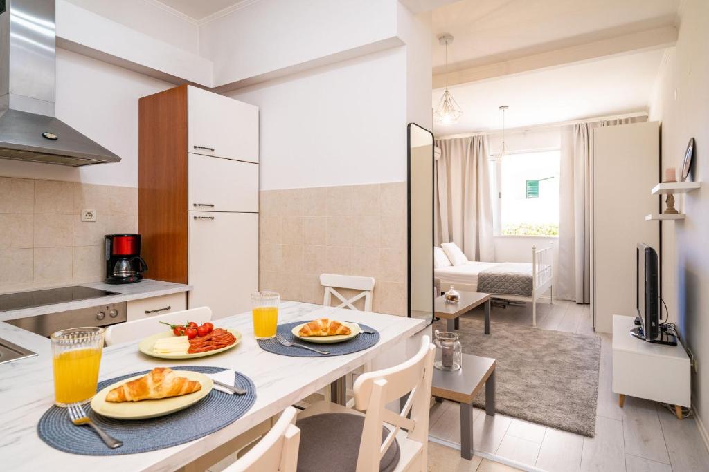 a kitchen with a table with two plates of food on it at Apartment Larissa in Dubrovnik