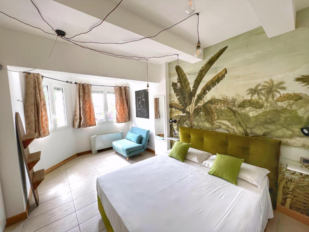 ラヴェンナにあるLeaf Apartmentのベッドと壁に絵が飾られた寝室