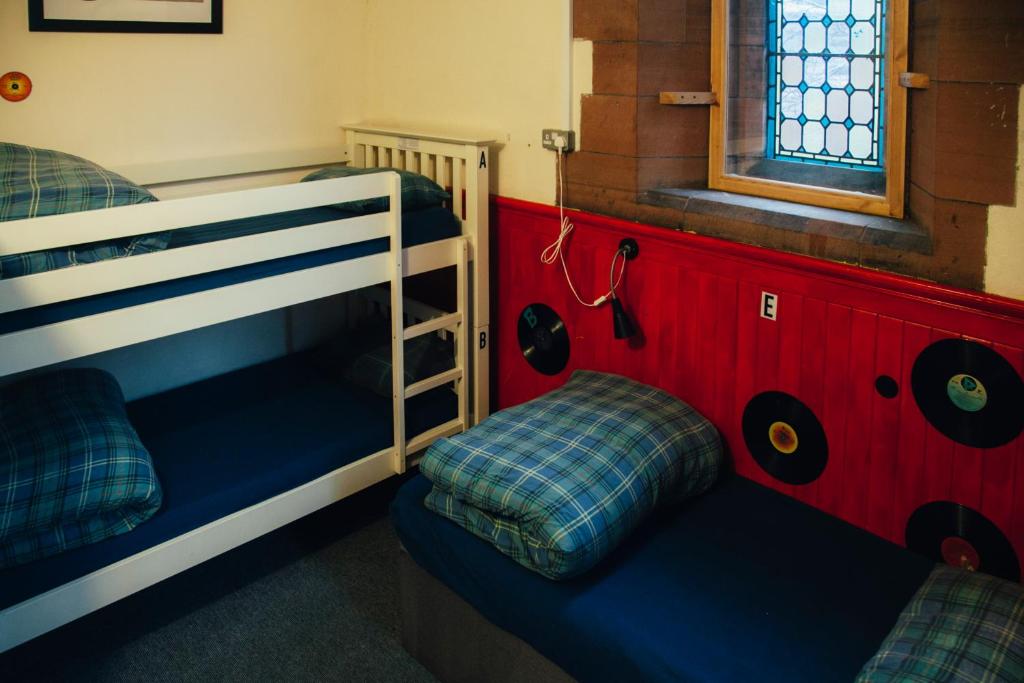 two bunk beds in a room with a window at Belford Hostel in Edinburgh