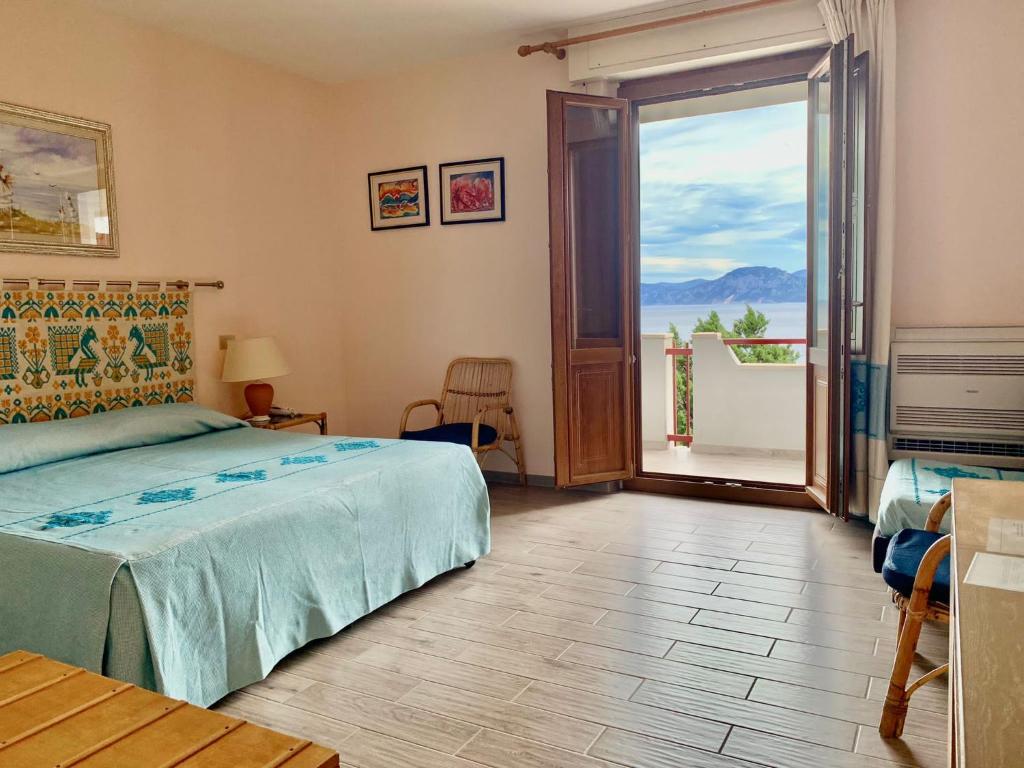 Postel nebo postele na pokoji v ubytování Hotel L'Oasi