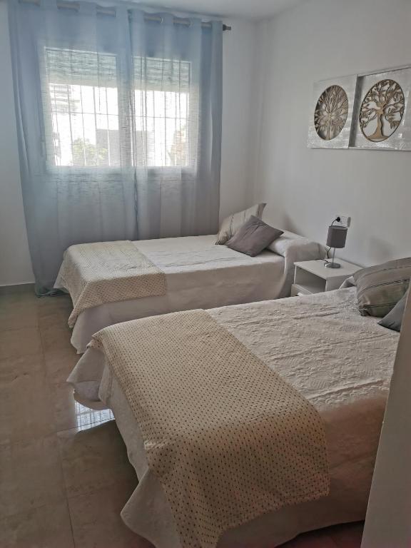 Postel nebo postele na pokoji v ubytování Manilva House