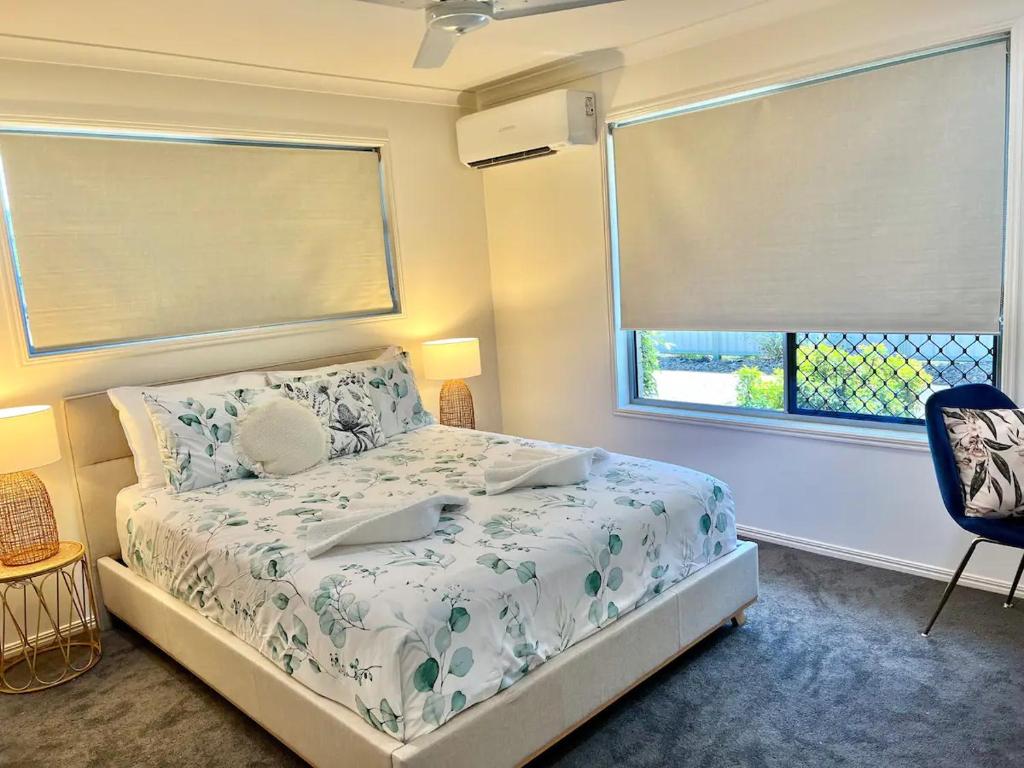 a small bedroom with a bed and a window at Lux in Bundy - Wifi, AC, Netflix and comfort in Bundaberg