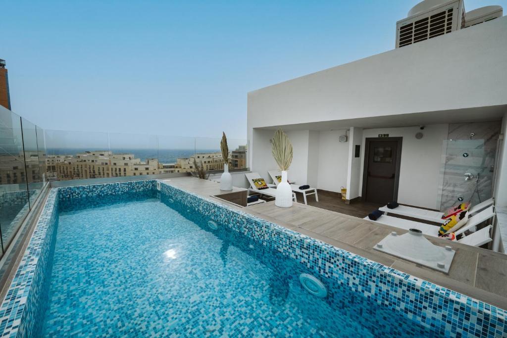 a swimming pool on top of a building at V Hotel in St Julian's