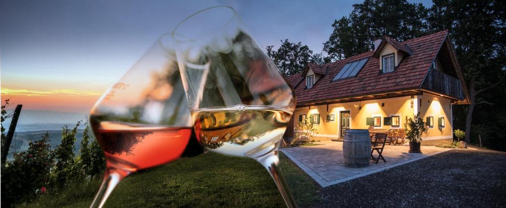 two glasses of wine in front of a house at Winzerhaus Oswald in Narrath