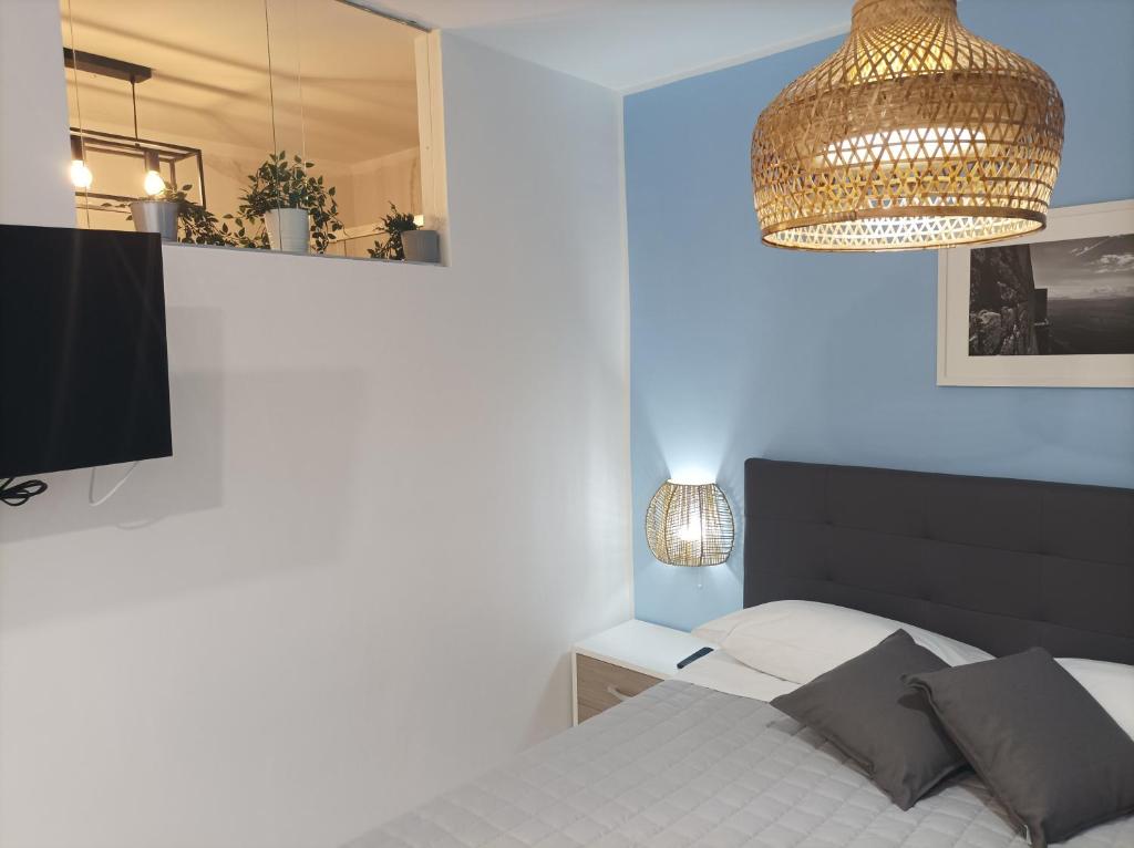a bedroom with a bed and a chandelier at Giata home in Naples