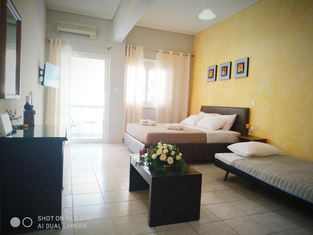 A bed or beds in a room at OSCAR STUDIO KALAMATA city centre